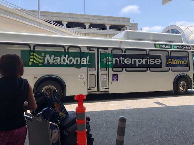 Pedestrians standing by Enterprise National Bus LAX